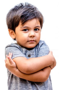 child with arms crossed