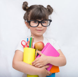 girl holding school supplies