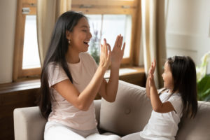 Mother and daughter clapping