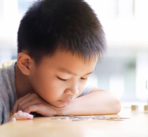boy looking at coins