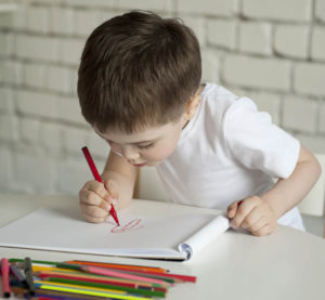 child writing in journal