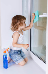 child washing a window