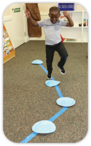 boy jumping paper plate "puddles"