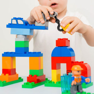 child building a bridge with blocks