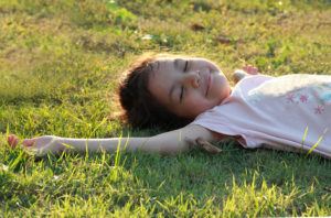 girl lying in the grass
