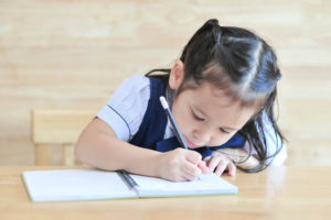 girl writing in journal