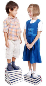 boy and girl standing on books