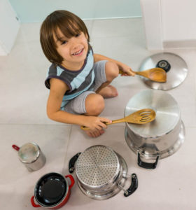 child drumming on pots and pans