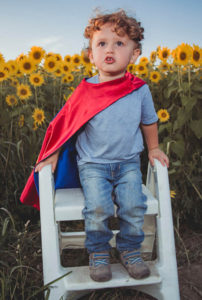 child wearing a cape