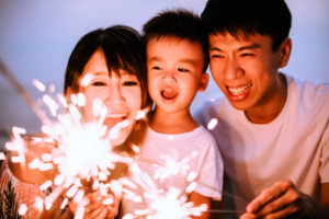 family looking at a sparkler