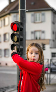 girl pointing to a traffic light
