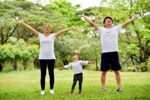 family stretching in the park