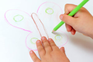 child drawing a butterfly