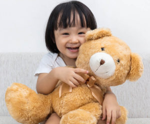 girl hugging a teddy bear