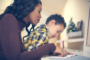 Mother and son writing together