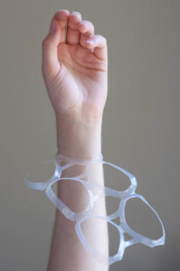 plastic six-pack ring on an adults wrist