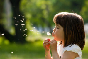 child with dandelion flower