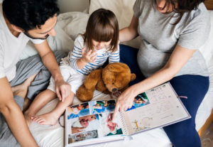 Family looking through childs baby book