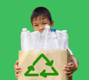 Child holding a bag of plastic bottles for recycling
